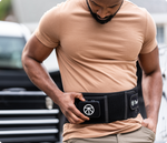 Load image into Gallery viewer, Man adjusting the controls of the Therabody Thermback LED that he is wearing