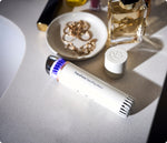 Load image into Gallery viewer, White Therabody TheraFace Depuffing Wand on a vanity table