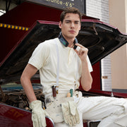 Male mechanic wearing Torras Coolify 3 around his neck while sitting on a car 
