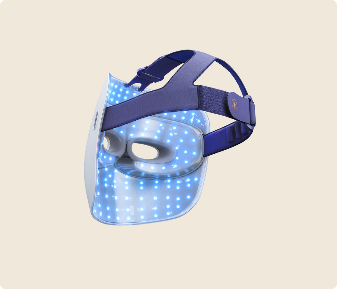 Slanted view of Therabody Theraface Mask Glo with blue light therapy activated