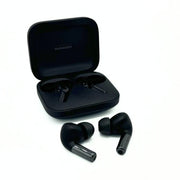 Comply True Grip Memory Foam Ear Tips on black earphones in front of black earphone casing