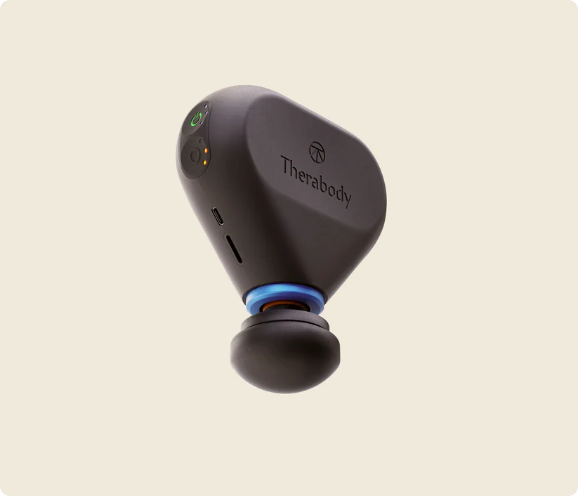 Therabody Theragun Mini Plus with the heat attachment, set to maximum speed and medium heat level floating