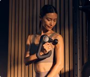 Woman using the Therabody Theragun Prime Generation 6 on her bicep