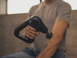 Load and play video in Gallery viewer, Man uses Therabody Theragun Prime fitted with the heated percussive attachment on various parts of his body