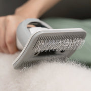 someone combing their pet with the Neabot P1 PRO Grooming Brush Attachment
