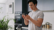 Man smiling at his phone