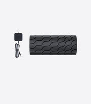 Therabody Wave Roller laid out beside its charging cable on a white background